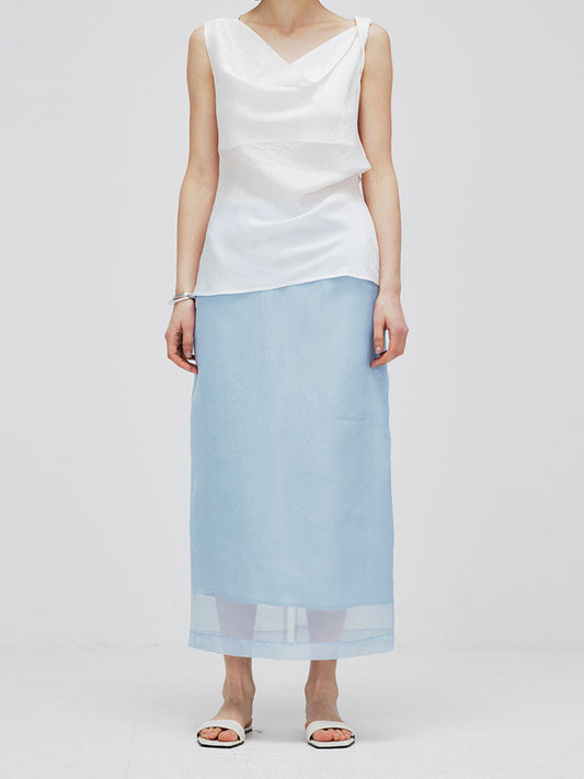 Woman wearing Arkin Studio high-waist mesh two-layer midi skirt in light blue, standing facing camera, on white background