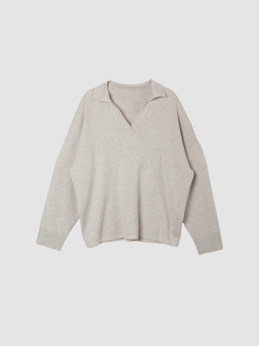 Shop the Arkin Studio knitwear collection, featuring the hero image of a classic taupe v-neck sweater with collar
