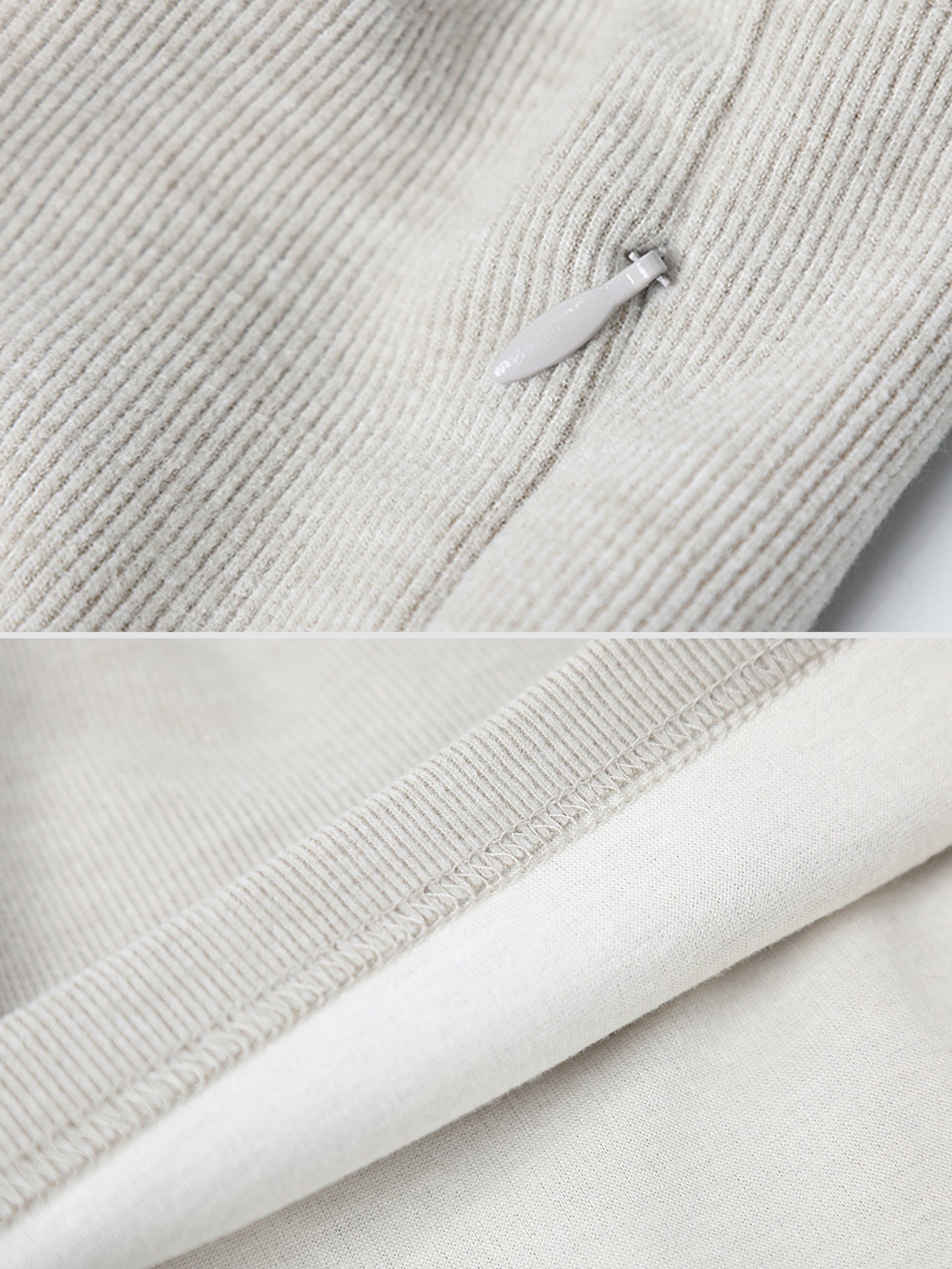 Close-up of Arkin Studio drawstring high waist sport shorts in light gray, focusing on the zipper detail and the rolled-up hem of the leg opening
