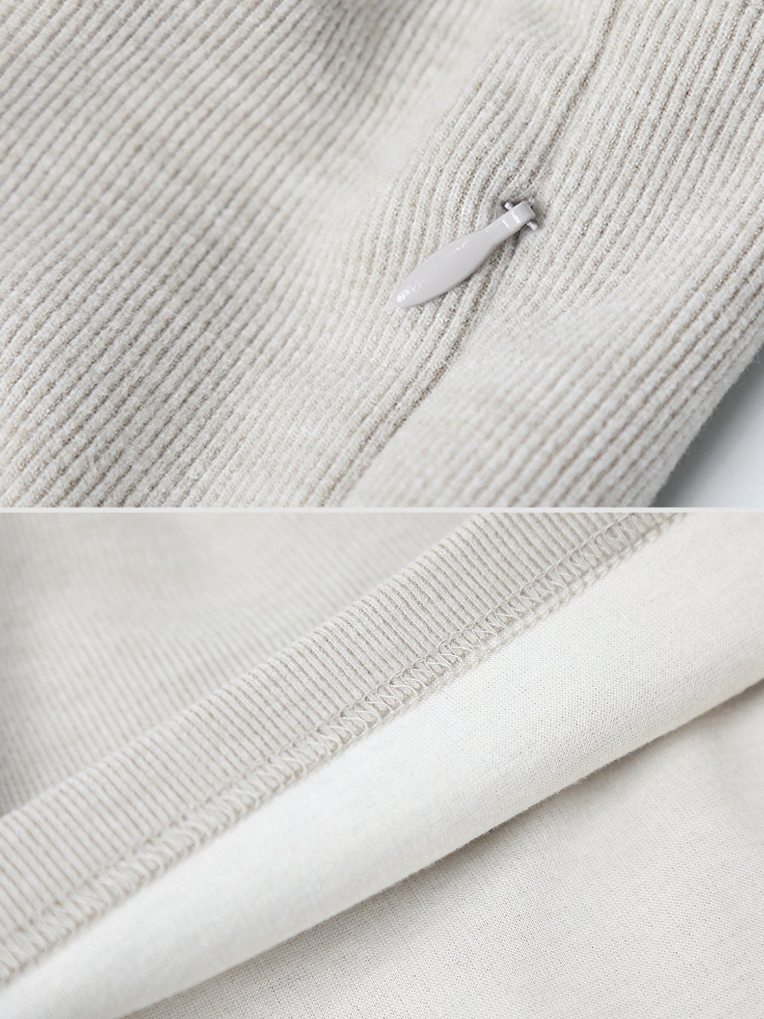 Close-up of Arkin Studio drawstring high waist sport shorts in light gray, focusing on the zipper detail and the rolled-up hem of the leg opening
